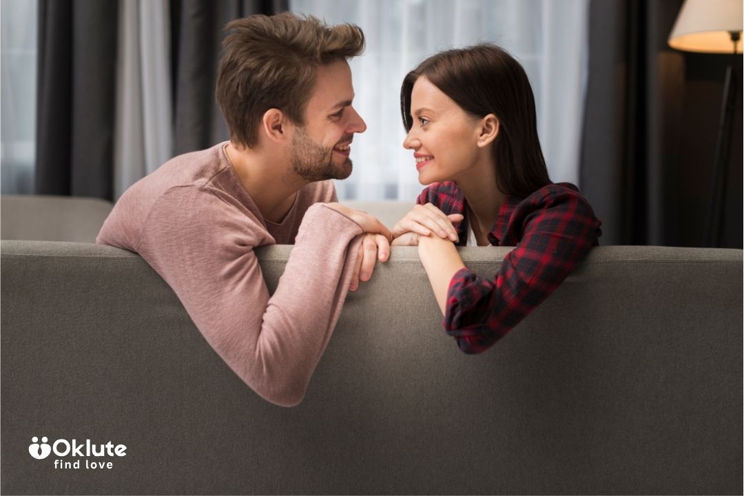 Cute beautiful romantic couple one in a long sleeve light maroon shirt while the other in a checkered crimson shirt.